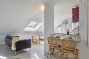 a living room with a couch and a table and chairs at Ático Pedro Romero in Ronda