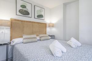 a bedroom with a large bed with white pillows at Ático Pedro Romero in Ronda