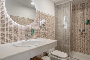 a bathroom with a sink and a shower and a toilet at Ático Pedro Romero in Ronda +18 photos