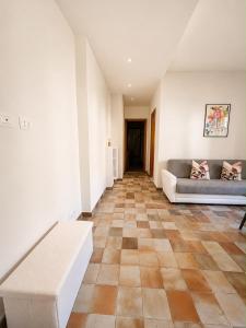 a living room with a couch and a table at Giuditta Apartment in Ciriè +5 photos