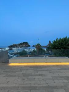 a room with a view of the water at night at Faraglioni Bay in Acitrezza