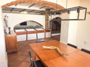 a dining room with a table and a bedroom at Palmeira Nature Lodge in Tavira