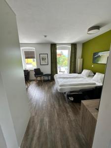 a bedroom with a bed and a desk in it at Appartement Marlene in Maishofen
