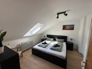 a bedroom with a bed with two pillows on it at Haus Hanni in Höchenschwand