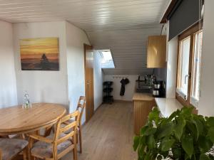 a dining room and kitchen with a table and chairs at Haus Hanni in Höchenschwand