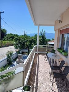 a balcony with chairs and a table with a view at Chrysafenia's House in Mandrákion