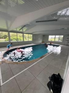 a large swimming pool with people in the water at 87 Loch Murray in Creetown