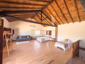 a large living room with two beds and a couch at Palmeira Nature Lodge in Tavira +35 photos