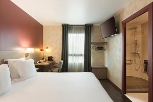 a hotel room with a large bed and a bathroom at Sure Hotel by Best Western Reims Nord in Reims