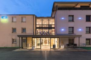 a building with a hotel sign on the front of it at Sure Hotel by Best Western Reims Nord in Reims +32 photos
