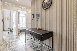 a room with a clock on the wall and a table at Valencia Apartamentos Goya in Valencia +290 photos