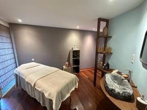 a bedroom with a bed and a chair in it at Authentique gite de village in Hotton