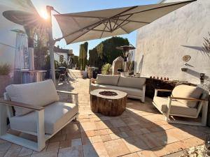 a patio with chairs and a table and an umbrella at THE PANAMERICANA, Air-Conditioned, 4K HD TV, Bose, Lounge in Riedstadt