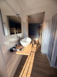 a bathroom with a white sink on a wooden counter at MarLee Lake Home in Castel San Vincenzo