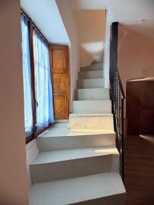 a staircase in a house with a wooden door at MarLee Lake Home in Castel San Vincenzo