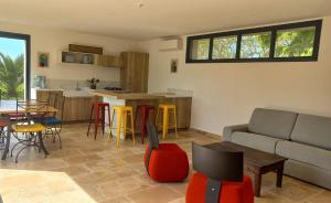 a living room with a couch and a table and chairs at Gite des Egadillias climatisé in Marsanne