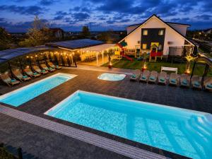an image of a swimming pool in front of a house at Domki Kotwica PARK Władysławowo - 3 Podgrzewane Baseny pod Kopułą in Władysławowo