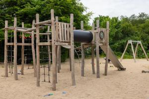 a playground in the sand with a slide at Holstebro Søpark in Holstebro