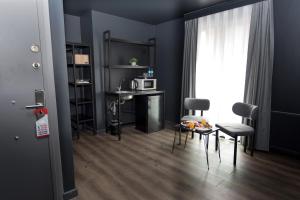 a living room with blue walls and a table and chairs at Arkem City Hotel in Istanbul