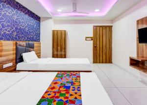 a room with a bed and a colorful rug at Hotel Lakeview Vadodara in Vadodara