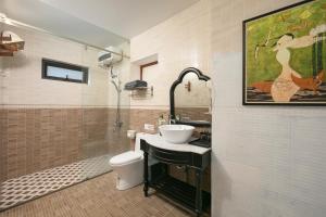 a bathroom with a sink and a toilet at Maison Bay View Villa Cat Ba in Ðồng Khê Sâu +32 photos