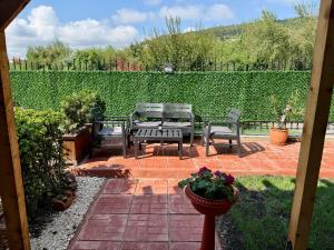 a patio with three chairs and a table and a fence at The Lemon Villa in Rogachevo
