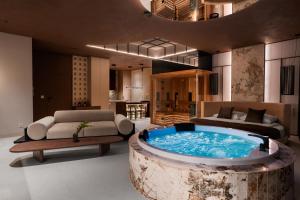 a living room with a large tub in the middle at Sky Tower Apartamenty - In The Sky Apartments in Wrocław