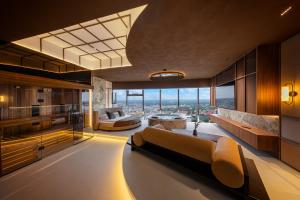 a living room with a couch and a large window at Sky Tower Apartamenty - In The Sky Apartments in Wrocław +248 photos