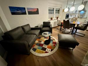 a living room with a couch and a table at Lucys Bungalow in Butjadingen