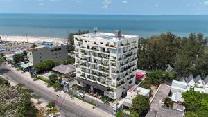 an aerial view of a tall white building next to a beach at Iconic Long Hai Hotel in Long Hai