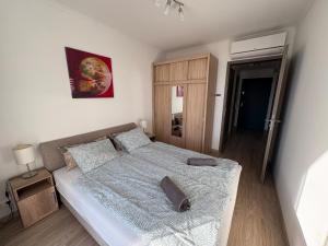 a bedroom with a large bed in a room at Seaforth Apartment in Siófok