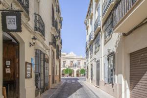 an empty street in a city with buildings at Martin De Aldehuela Apartment in Ronda