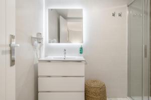 a white bathroom with a sink and a shower at Vicente Espinel Apartment in Ronda +15 photos
