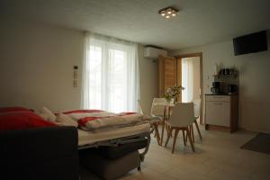 a bedroom with a bed and a kitchen with a table at FeWo Reutlingen Ganghoferstr in Reutlingen