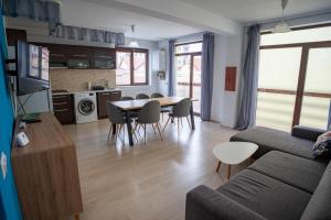 a living room with a couch and a table and chairs at Barrique 24-4 - Breakfast delivered & Minibar - Free Parking -Officially classified guesthouse in Braşov