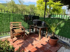 a grill and a bench on a brick patio at The Lemon Villa in Rogachevo