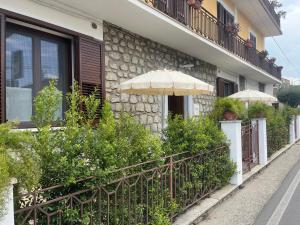 a building with two umbrellas on the side of it at Dimora Patrizia in Scario