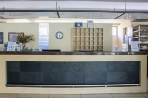 a counter in a library with a clock on the wall at Jason Hotel Apartments in Rethymno +70 photos