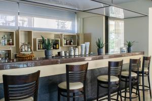 a bar with stools at a restaurant at Jason Hotel Apartments in Rethymno