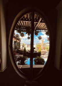 a view of a pool through a round window at Casa Grande Luxury Boutique Hotel in San Miguel de Allende
