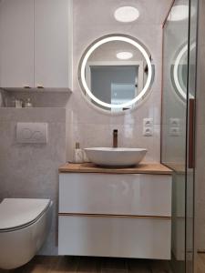 a bathroom with a white sink and a mirror at Start na Szlak - dom Rytro in Rytro