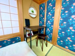 a bedroom with a desk and a bed and a mirror at ParkView SAKURA in Aomori