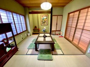 a room with a table in the middle of a room at ParkView SAKURA in Aomori