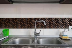 a kitchen sink with a faucet on top of it at Sapphire Chalet - Moieciu de sus in Moieciu de Sus +81 photos