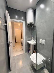 a bathroom with a shower and a sink and a toilet at Coastal Pine Appartment in Golem +12 photos