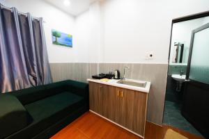 a small bathroom with a sink and a couch at Danna House Da Nang BNB in Danang +34 photos