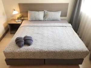 a bed with two pillows on it in a bedroom at Sunday Ayothaya Hotel in Phra Nakhon Si Ayutthaya