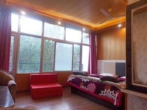 a bedroom with a bed and a large window at Hotel Pine View Villa in Dagshai +26 photos