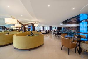 a restaurant with tables and chairs in a building at Four Points by Sheraton Hangzhou, Binjiang in Hangzhou
