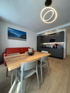 a dining room with a table and a red couch at Rivacentro 4 in Riva del Garda +14 photos